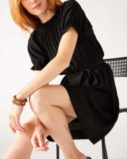 Ibiza Dress 27 Ibiza Dress -Mersea womens black ruffled shoulder midi dress sitting arms legs crossed