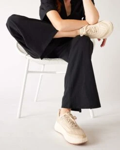 Traveler Tee Pant -Mersea womens black wide leg ankle side slit elastic waist front view sitting legs crossed