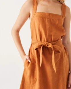 Jolie Linen Sundress -Mersea womens clay summer lightweight above the knee linen sleeveless A line sundress with self belt trapunto stitch bra friendly straps and side seem pockets front view closeup