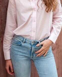 Nomad Cropped Mini Boot Jean -Mersea womens light blue 5 pocket universal mid rise fit wide leg stretchy cropped mini boot jeans front view close up waist line detail