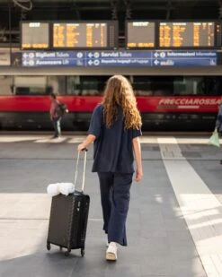 Traveler Tee Pant -Mersea womens navy blue wide leg ankle side slit elastic waist pant rear view full body travel destination look