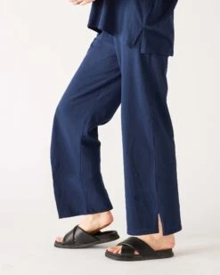 Traveler Tee Pant -Mersea womens navy blue wide leg ankle side slit elastic waist pant side view knee bend