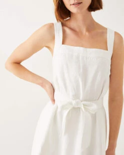 Jolie Linen Sundress -Mersea womens summer lightweight above the knee white linen sleeveless A line sundress with self belt trapunto stitch bra friendly straps and side seem pockets closeup