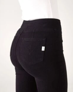 Nomad Pull-On Cigarette Jean 11 Nomad Pull-On Cigarette Jean -Mersea womens travel ultra stretch black nomad pull on ankle cigarrette demin jeans with side lock zipper closeup back pocket detail