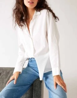 Brontë Relaxed Button Up Shirt 32 Brontë Relaxed Button Up Shirt -Mersea womens white breathable relaxed fit button up shirt front view sitting