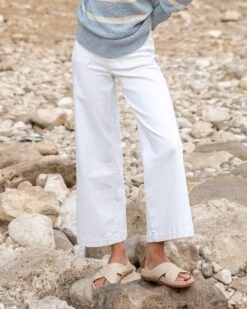 Nomad Cropped Sailor Jean 20 Nomad Cropped Sailor Jean -Mersea womens white cropped sailor jean front view rocky beach